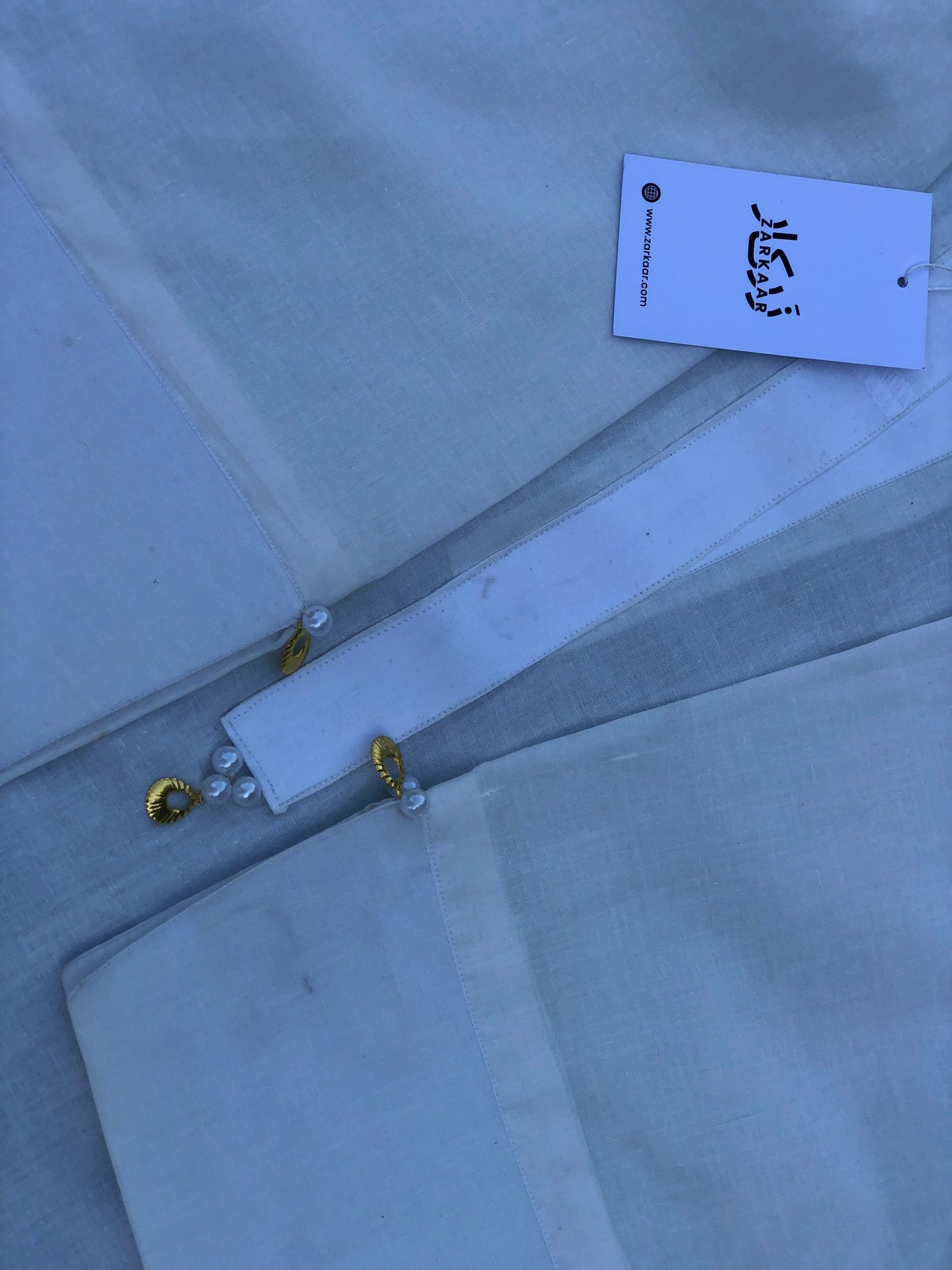 Light gray fabric with a label on a light blue background