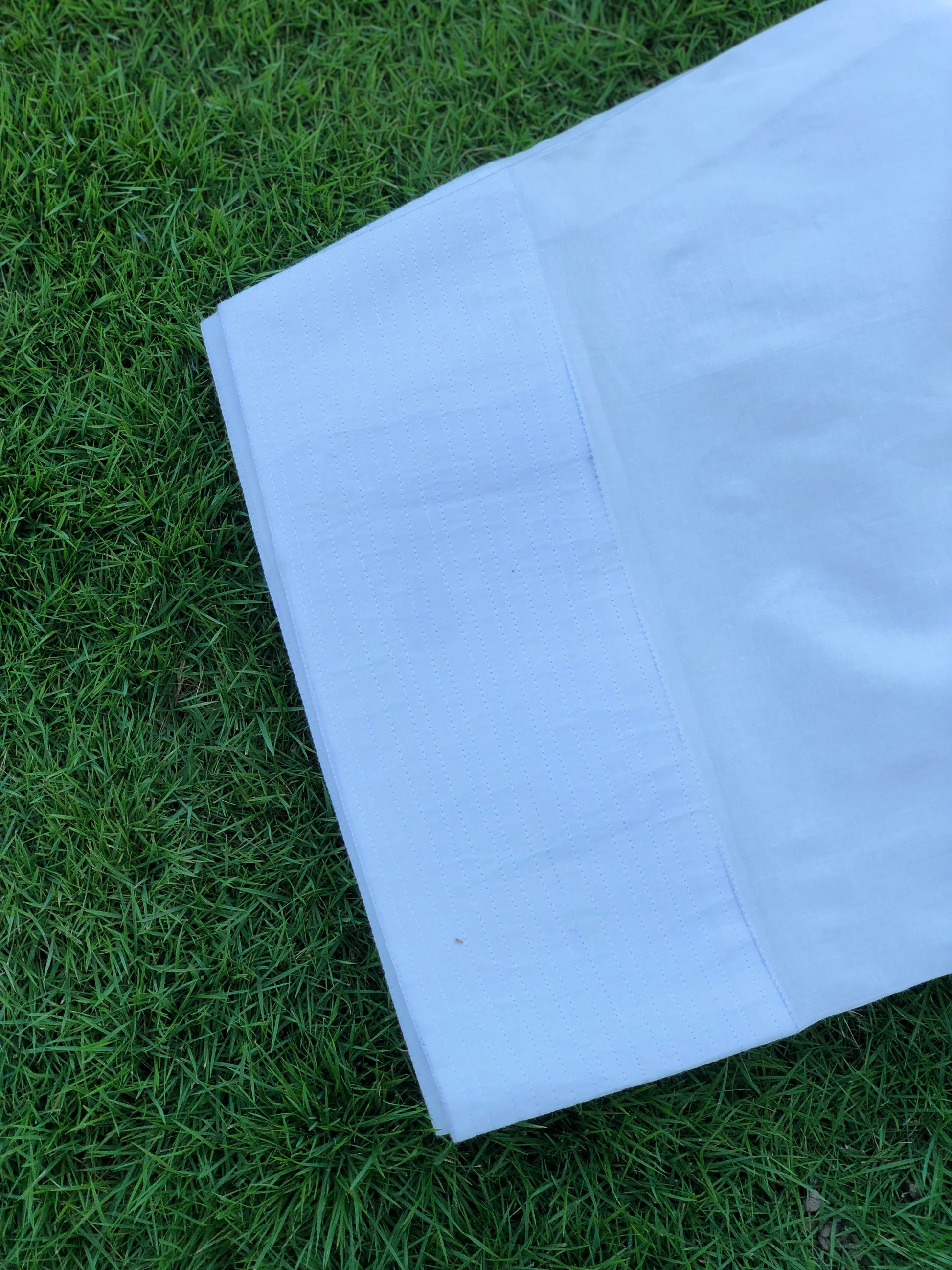White fabric on green grass
