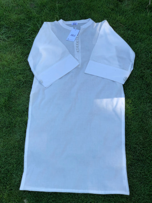 White dress with sheer sleeves on a grassy background