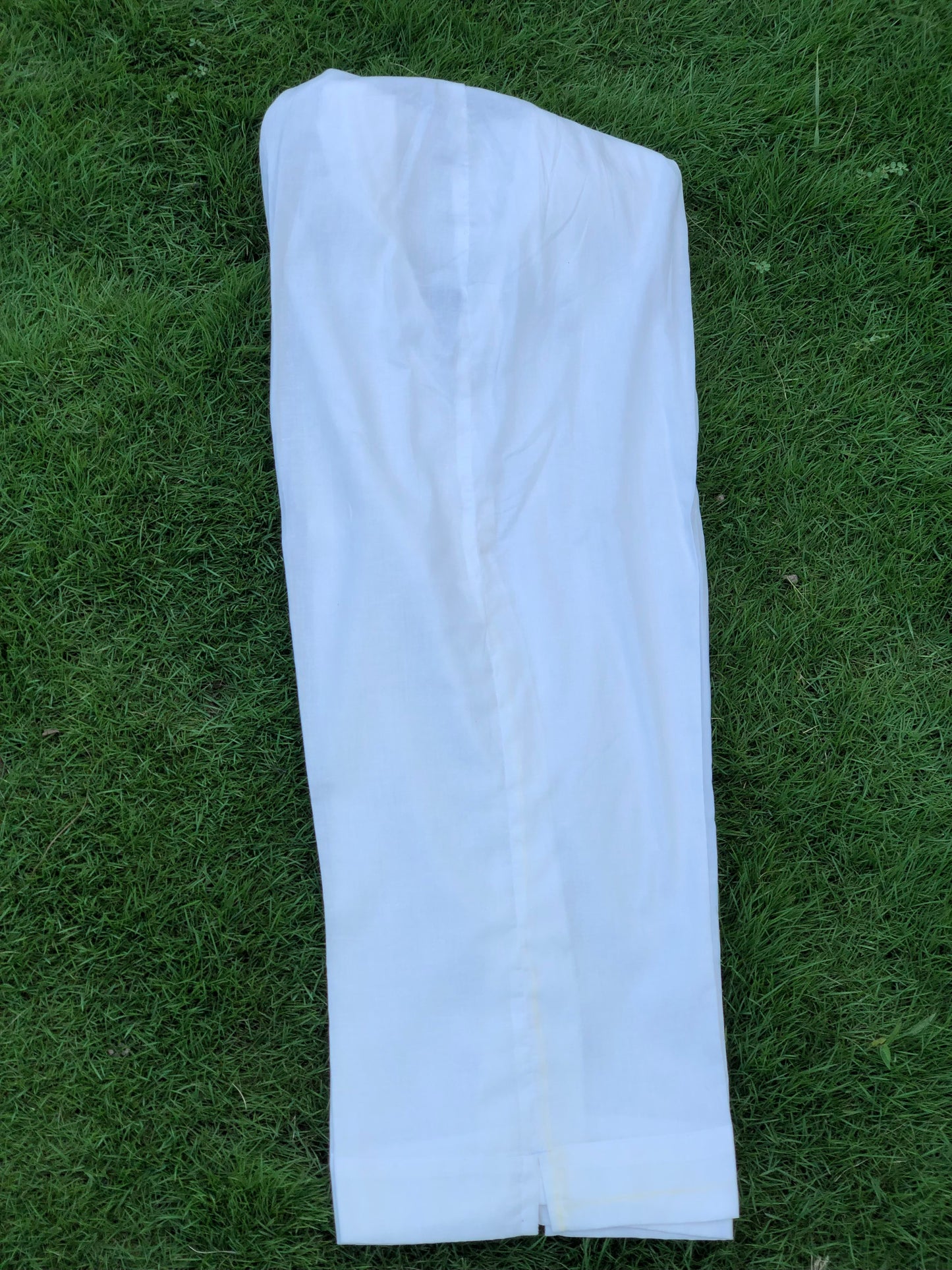 White pants on a grassy background